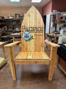 Oversized natural stained surfboard-shaped back adirondack chair with Pacifico decal